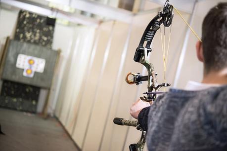 Man Shooting Compound Bow At Target