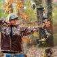 Bow shooting a compound bow in woods