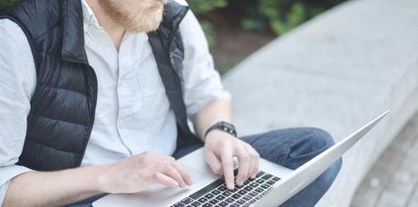 man holding computer outside
