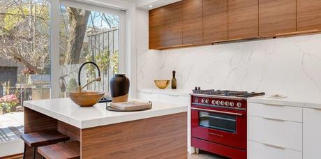 kitchen island near gas range beside base cabinets