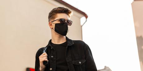 man with a face mask and sunglasses