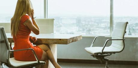 woman on phone sitting on office chair with rollerblade wheels