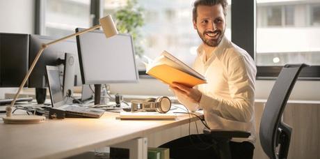 man sitting on office chair with rollerblade wheels