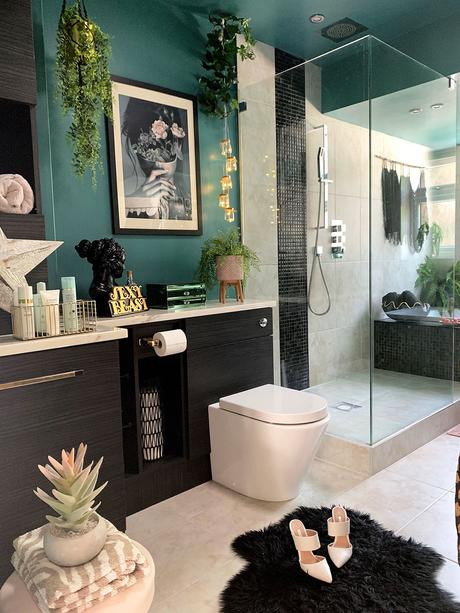 Quirky bathroom decor. Green and black color palette with lush green house plants