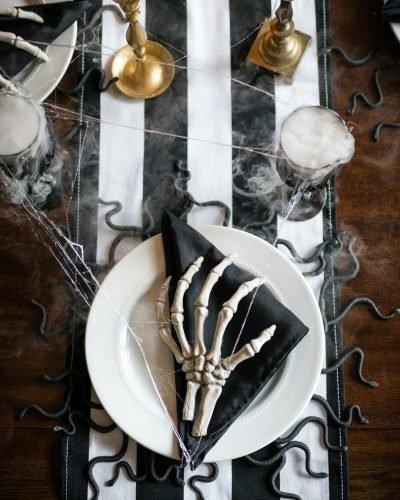 halloween bridal shower ideas black white tablecloth skeleton hand dinner carefreeblondeblog