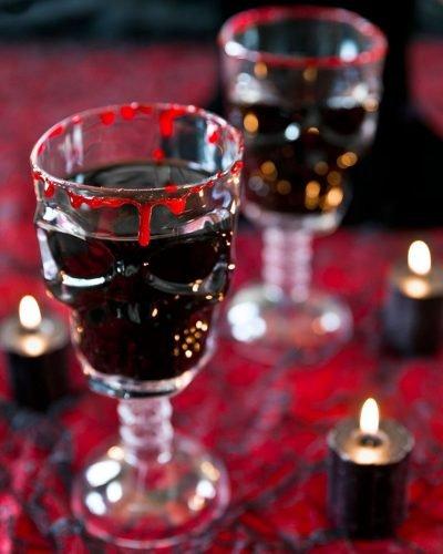 halloween bridal shower ideas red cocktail in skull glass pizzazzerie