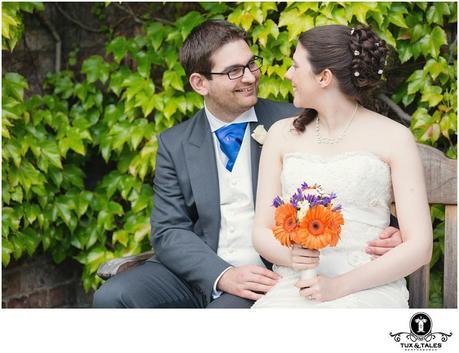 Quirky ytorkshire wedding couple at York St. John University with orange flowers