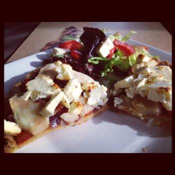 Feta tart on a white plate with salad