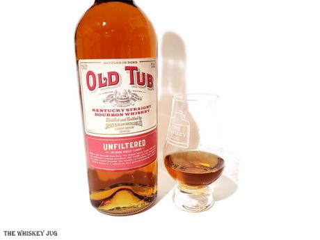 White background tasting shot with the Old Tub Bottled In Bond Bourbon bottle and a glass of whiskey next to it.