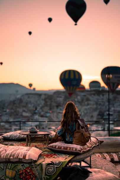 woman looking at hot air balloons