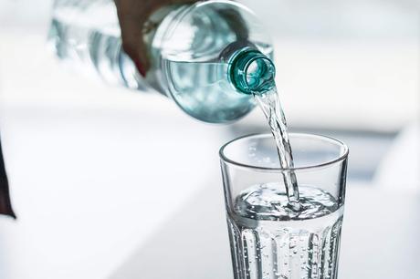 Pouring Water from PET Bottle into a Glass