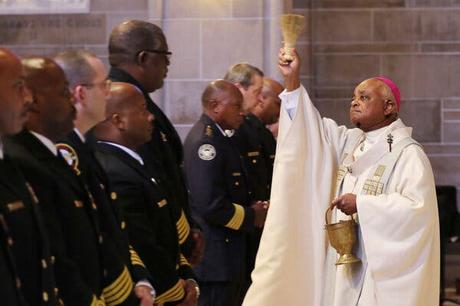 Rather Shocking Racist, White Catholic News Breaking Today Archbishop Wilton Gregory, right, celebrating Mass and blessing the badges of first responders in Atlanta in 2015.