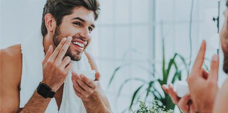 man applying beard balm 