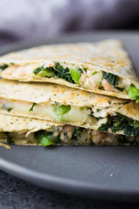 Stack of three Smashed White Bean and Spinach Quesadillas on gray plate