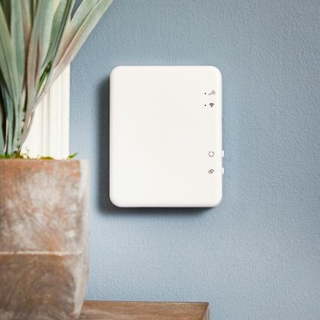 Milano Connect - Wi-Fi Gateway Hub for Smart Radiator Thermostat on a blue wall