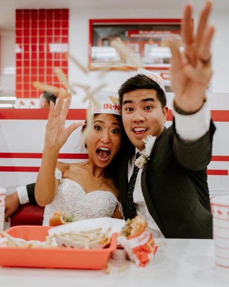 Bride and groom eating fast food