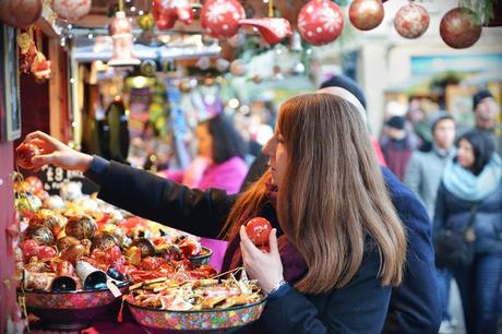 Woman choosing bauble from stall