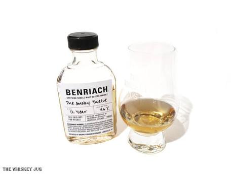 White background tasting shot with the BenRiach Smoky Twelve bottle and a glass of whiskey next to it.