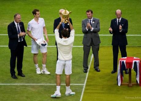 Roger Federer lifts the Wimbledon 2012 men's trophy as Andy Murray looks on