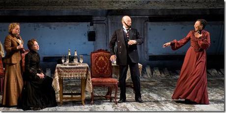 (right to left) Natasha (ensemble member Alana Arenas) is startled by Kulygin’s (ensemble member Yasen Peyankov) fake beard as Masha (Carrie Coon) and Irina (Caroline Neff) look on in Steppenwolf Theatre Company’s production of Anton Chekhov’s Three Sisters, adapted by ensemble member Tracy Letts, directed by ensemble member Anna D. Shapiro. 