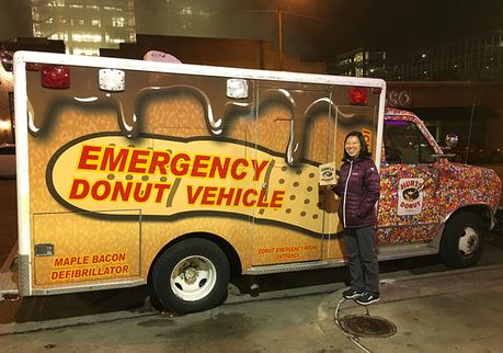 Katie next to the Hurt's Donut Emergency Donut Vehicle in downtown Tulsa