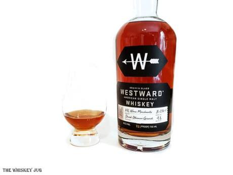White background tasting shot with the Westward Single Barrel American Single Malt Whiskey bottle and a glass of whiskey next to it.