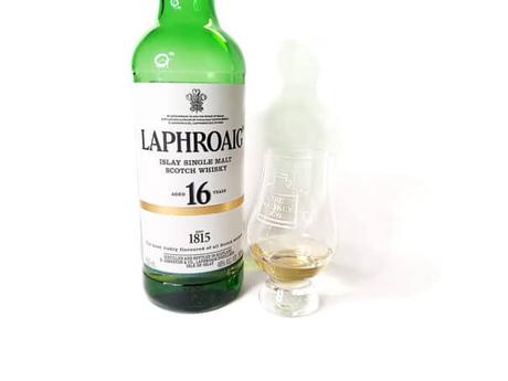 White background tasting shot with the Laphroaig 16 Years Limited Edition bottle and a glass of whiskey next to it.