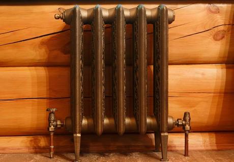 Cast iron retro radiator in timber home