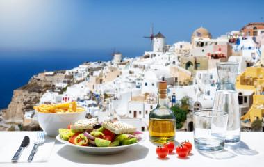 Greece private trip: Tasty Greek food with salad, fried potatoes and fresh olive oil at Oia in Santorini