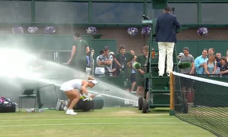 female tennis player being drenched by sprinklers at Wimbledon