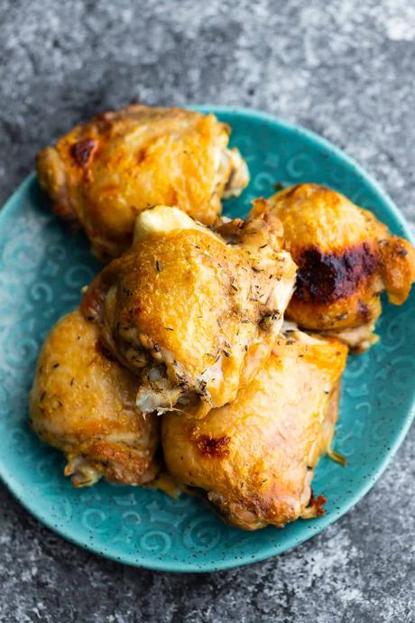 bone in skin on chicken thighs on a plate