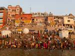 Many local Indians at Kedar Ghat with a temple in the background