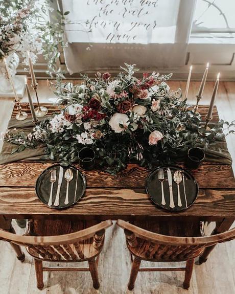 wedding decor trends dark table runner with dark flowers and greenery and flowers karra leigh photography