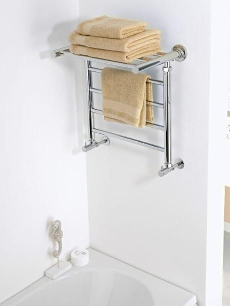 shelf style heated towel rail in a bathroom with towels