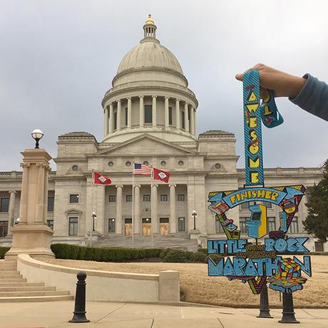 2020 Little Rock Marathon medal in front of State Capitol