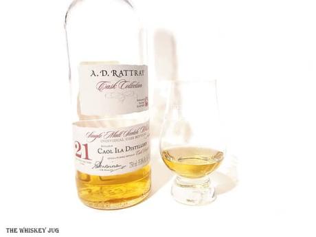 White background tasting shot with the 1991 A.D. Rattray Caol Ila 21 Years bottle and a glass of whiskey next to it.