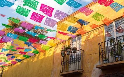 Enchanting Travels Mexico Tours Colorful paper flags over street