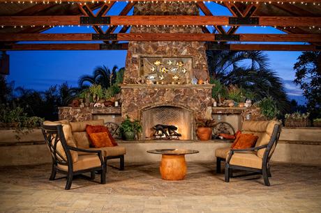 Outdoor patio cover with stone fireplace