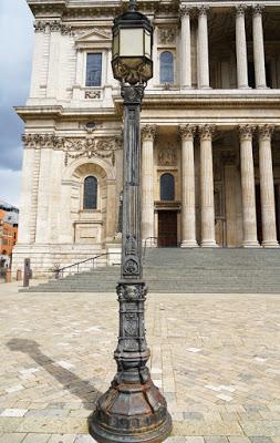 Photograph of an elaborate cast-iron lamp post in front of the west facade of the cathedral. Its appearance is described more fully in the text.