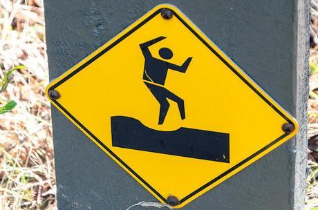 man dancing on danger sign