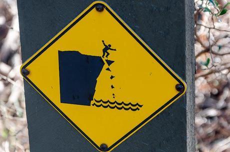 man falling on danger sign