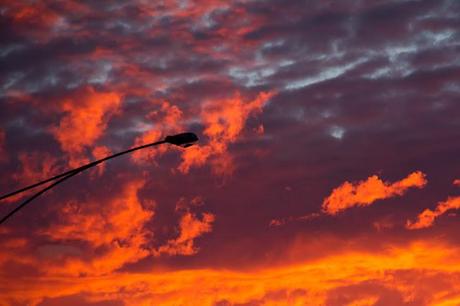 street light in front of red sunrise