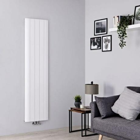 vertical aluminum radiator in a gray living room 