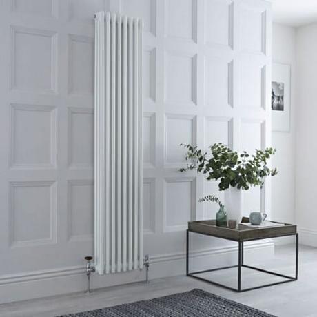 dual fuel vertical column radiator on a panelled wall