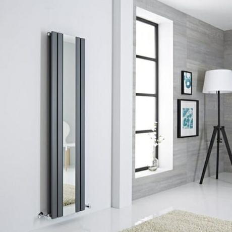 vertical mirrored radiator in a minimal room