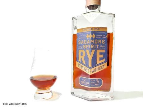 White background tasting shot with the Sagamore Spirit Double Oak bottle and a glass of whiskey next to it.
