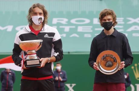 tennis players holding winner trophies