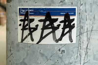 Cobblestone streets, overhead wires, and a sticker [Hoboken]