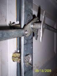 There are two bars running from the handle that release the door to be unlocked manually, and there is also a button on it which moves the bars across to lock the door. Old Manual Garage Door Lock