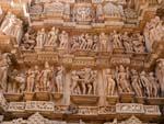 Two rows of sculptures including divine figures, couples and erotic scenes at Lakshmana Temple